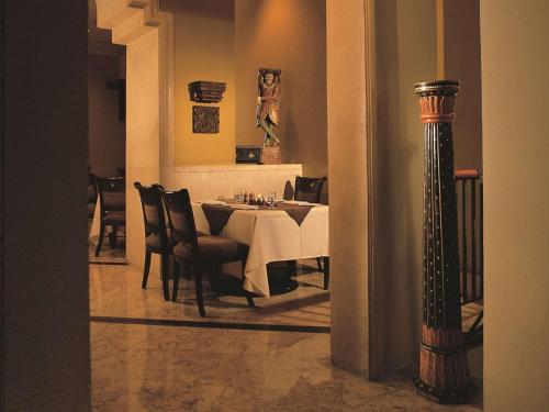 a dining room with a white table and chairs at Hilton Cairo Grand Nile in Cairo