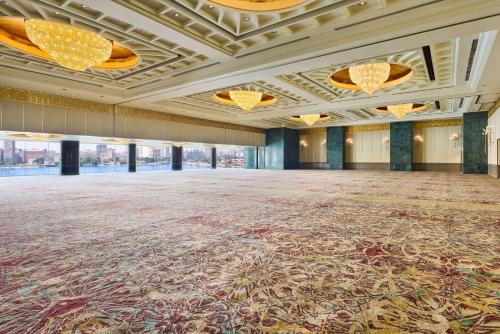 a large ballroom with a large carpeted floor and chandeliers at Hilton Cairo Grand Nile in Cairo