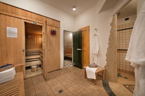 a bathroom with a walk in shower and a toilet at Hotel Posta in Livigno