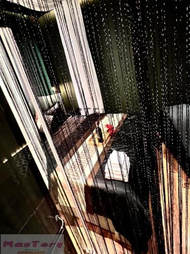 a view of a room through a wire fence at Mastery Hotel Nhà Bè in Ho Chi Minh City