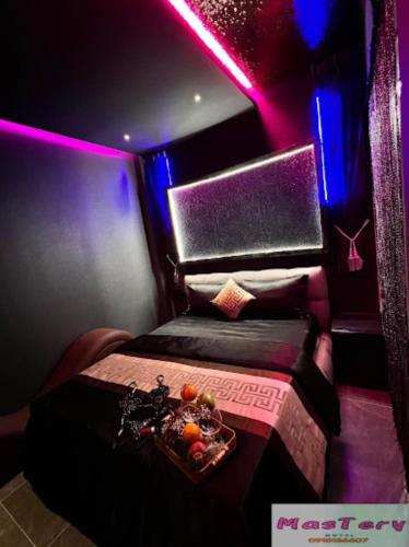 a room with a bed with a bowl of fruit on it at Mastery Hotel Nhà Bè in Ho Chi Minh City
