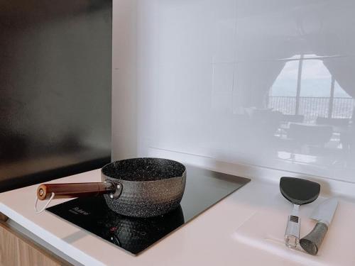 a mortar and pestle on a counter next to a window at Cozy Kenwingston Platz KL 2-5 Pax 2BR & 2BR FrePakin Netflix 2802 in Kuala Lumpur