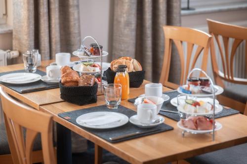a wooden table with food on top of it at Roots Hotel Restaurant in Gomaringen