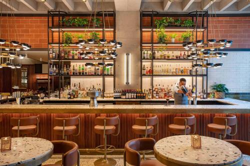 a man standing at a bar in a restaurant at Element Philadelphia Downtown in Philadelphia