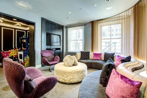 a living room with a couch and chairs at The Midland Hotel, Chicago, a Tribute Portfolio Hotel in Chicago