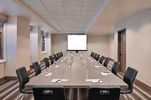 a large conference room with a long table and chairs at The Midland Hotel, Chicago, a Tribute Portfolio Hotel in Chicago