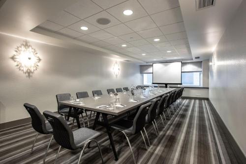 a conference room with a long table and chairs at The Midland Hotel, Chicago, a Tribute Portfolio Hotel in Chicago