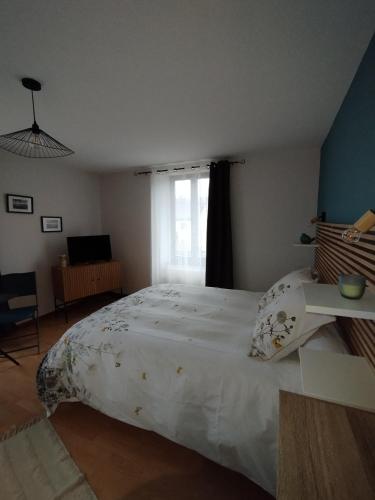 a bedroom with a large white bed and a window at Chambre d'hôte Nature Domaine du Bagnerot in La Chapelle-aux-Bois