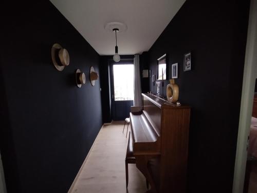 a hallway with black walls and a window at Chambre d'hôte Nature Domaine du Bagnerot in La Chapelle-aux-Bois