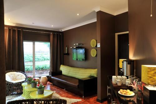 a living room with a couch and a table at Glendower View Guest House in Johannesburg