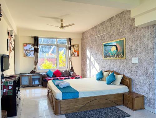 a bedroom with a bed and a window at kasauli Auriga 2BHK Villa Pvt Stay I Open Air Terrace I Kitchen Livingroom I Lawn Bonfire I Gaming Zone in Kasauli