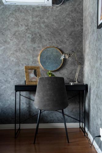 a desk with a mirror and a chair on it at The Gracious in Sapporo