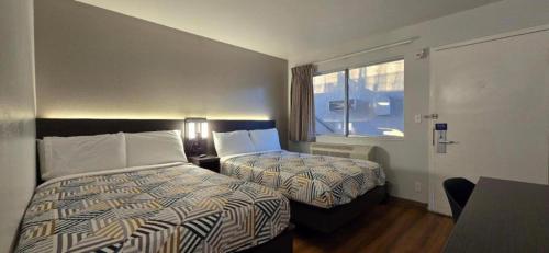 a hotel room with two beds and a window at Motel 6-Slidell, LA - New Orleans in Slidell