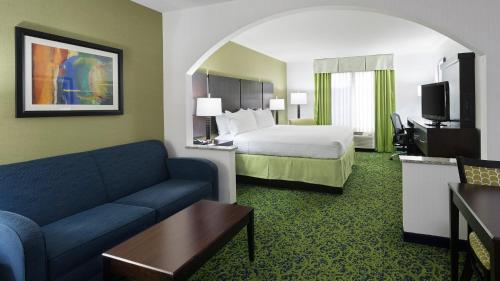 a hotel room with a bed and a couch at Holiday Inn Express and Suites Stroudsburg-Poconos by IHG in Stroudsburg