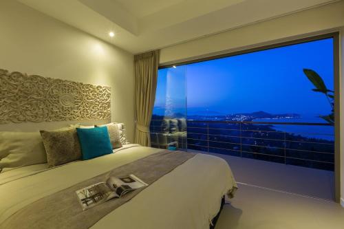 a bedroom with a large window with a large bed at 2br boutique style villa Lipe in Bang Rak Beach