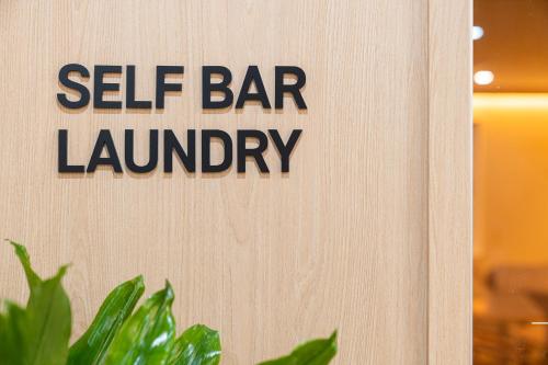 a sign that says self bar laundry on a wall at Cheonan H-Avenue Cheonan Buldang in Cheonan