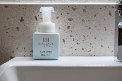 a bottle of mouthwash sitting on top of a sink at Cheonan H-Avenue Cheonan Buldang in Cheonan