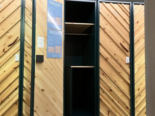 a black elevator in a room with a wooden wall at IceHotel in Jukkasjärvi