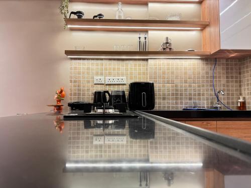 a kitchen with a counter top with two microwaves at The Manor in Pune