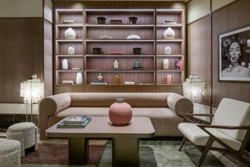 a living room with a couch and a table at AC Hotel Milano by Marriott in Milan