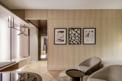 a living room with two chairs and a table at AC Hotel Milano by Marriott in Milan