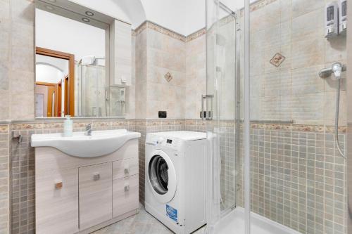a bathroom with a washing machine and a sink at MUG1 -Sesto San Giovanni- Comfort House - in Sesto San Giovanni