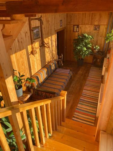 a couch sitting on a wooden staircase in a cabin at Під Явором in Vorokhta