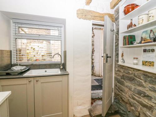 a kitchen with a sink and a window at Holme Fell View in Sedbergh