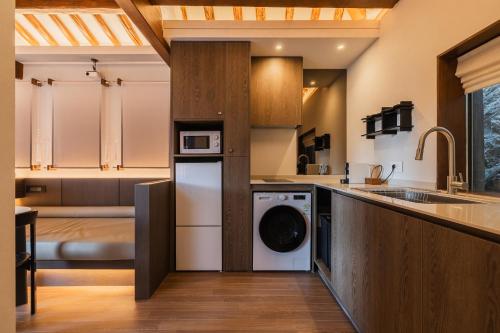 a kitchen with a washer and dryer in a room at Luxury Hanok Stay in Breeze in Seoul