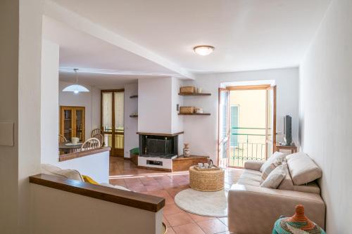 a living room with a couch and a fireplace at Casa Bar - Cozy Apartments Lake Como in Dongo