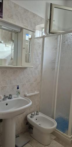 a bathroom with a sink and a toilet and a shower at Kenzia in Agnone Bagni