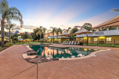 a swimming pool in the middle of a yard at Murray River Resort in Moama