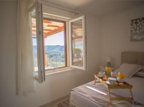 a room with a bed and a table with a window at Apartment Peace and quiet in Jelsa