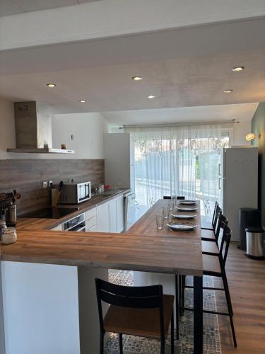 une cuisine avec une grande table et des chaises en bois dans l'établissement St Cyprien Belle maison renovee avec jardin 4 a 6 p, à Saint-Cyprien