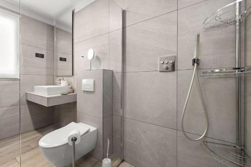a bathroom with a shower and a toilet and a sink at Villa Speranza with Illuminated Pool in Pula