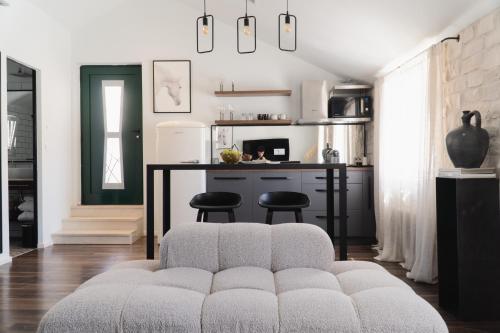 a living room with a couch and a kitchen at Kalavanda Apartment in Hvar
