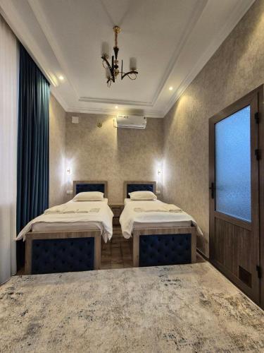 a hospital room with two beds and a window at YASMIN in Samarkand