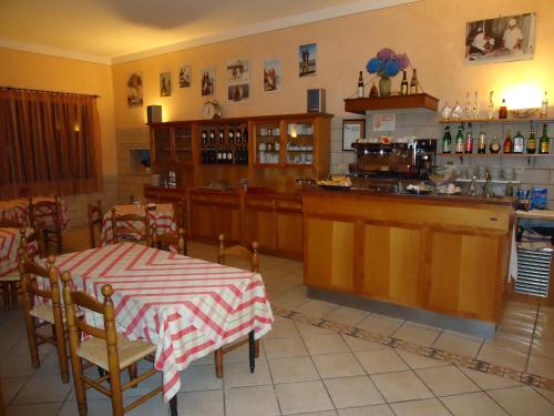 a restaurant with a table and a kitchen with a counter at Albergo La Mimosa in Lerici