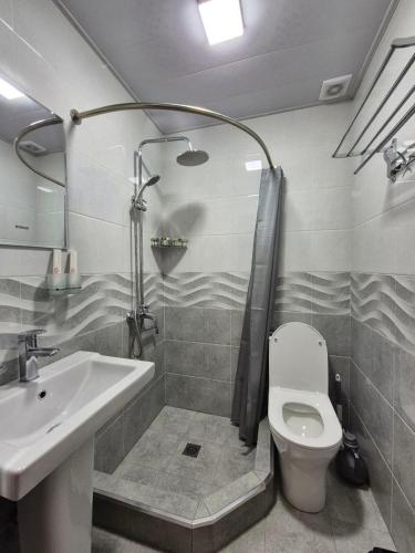 a bathroom with a sink and a toilet and a shower at YASMIN in Samarkand