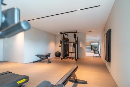 a room with a gym with a bench and equipment at Savoy Monumentalis your home in Madeira Island in Funchal