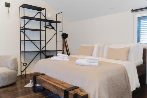 a bedroom with a large bed with towels on it at Kalavanda Apartment in Hvar