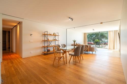 a dining room and living room with a table and chairs at Savoy Monumentalis your home in Madeira Island in Funchal