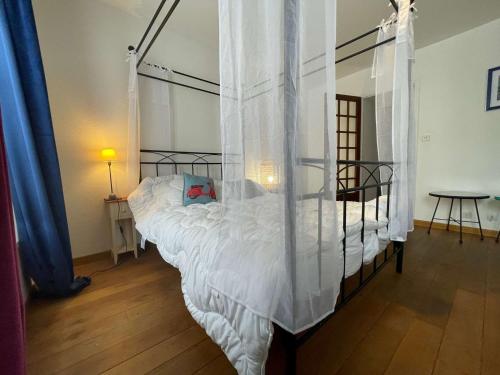 a bedroom with a bed with a canopy at Appt 3 pièces LA ROCHELLE - LR180-030 in La Rochelle