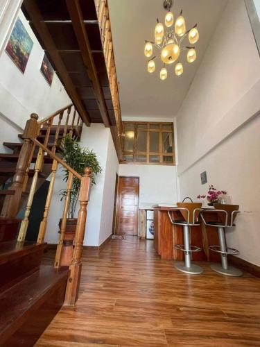 a living room with a staircase and a chandelier at Appleton Liitle Paradise Beach Resort & Restaurant Seaside Villa in Real