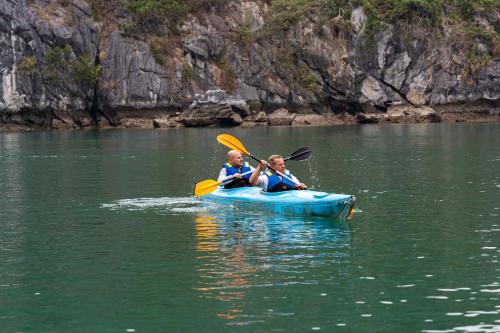 two people in a blue kayak in the water at Indochine Grand Lan Ha Bay in Ha Long