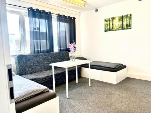a living room with a couch and a table at Apart Residence KK in Glinde