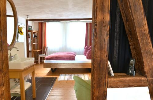 a bedroom with a bed and a sink in a room at Apartmenthaus Duderstadt in Duderstadt