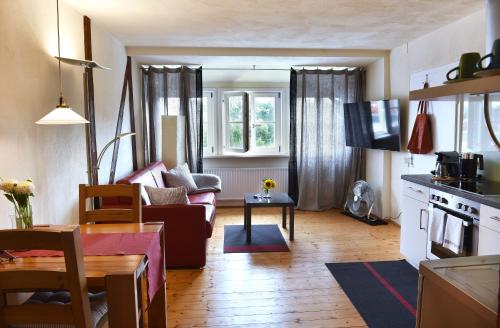 a living room with a couch and a table at Apartmenthaus Duderstadt in Duderstadt