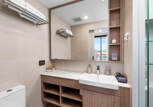 a bathroom with a sink and a mirror at Laguna Skypark by My Home Phuket in Bang Tao Beach