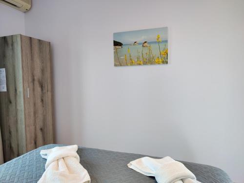 a bedroom with a bed with two towels on it at Kapases Studios & Apartments in Peroulades